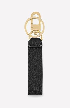 a black leather keychain with a gold ring on the front and bottom part