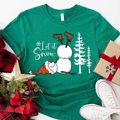 a green shirt with a snowman on it