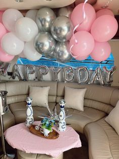 a living room filled with furniture and balloons