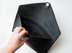 This black leather envelope clutch has simple and delicate design. It's beautifully compliment any of your outfits-be it casual or bizarre. The clutch is made of black, matt genuine leather, closes with magnet, hided under leather loop. There is also one zipper pocket inside. It is 100% handmade and designed in our beautiful workshop ErikasLeather. Main color: Black Material: Black leather Magnet closure Measurement: Width 35 cm (~ 14 inch) Height 20 cm (~ 8 inch) Please feel free to contact us Minimalist Black Leather Clutch, Black Leather Minimalist Clutch, Black Envelope Clutch For Daily Use, Business Clutch With Interior Card Slots In Black, Black Clutch With Interior Card Slots For Business, Black Business Clutch With Interior Card Slots, Black Office Clutch With Magnetic Closure, Modern Black Clutch With Magnetic Closure, Black Clutch With Magnetic Closure