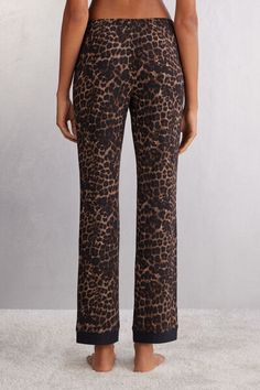 Full length pants in soft animal-print micro-modal with contrasting black detail on the hem. Leopard Print Loungewear Bottoms, Leopard Print Long Pants For Loungewear, Chic Stretch Leopard Print Bottoms, Stretch Leopard Print Loungewear Bottoms, Stretch Leopard Print Bottoms For Loungewear, Leopard Print Trousers For Loungewear, Leopard Print Loungewear Trousers, Stretch Leopard Print Pants For Loungewear, Undershirt Tank Top