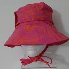 Juicy Couture Women's Printed Bucket Hat Pink Features A Fun Wavy Print Pink And Orange Designs Adjustable Neck Tie Gold Tone Hardware One Size Trendy Pink Adjustable Sun Hat, Pink One Size Bucket Hat, Pink Bucket Hat With Adjustable Fit And Curved Brim, Adjustable Pink Bucket Hat, Pink Bucket Hat One Size Fits Most, Casual Pink Bucket Hat One Size, Casual Pink Sun Hat, Pink Brimmed Hat One Size, Trendy Pink Bucket Hat For Beach