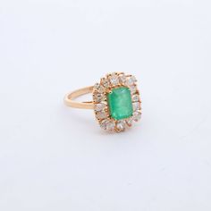 Indulge in luxury with our exquisite Emerald and Diamond Cocktail Ring. Adorned with stunning emeralds and diamonds, this ring exudes sophistication and elegance. Elevate any outfit with this timeless piece, perfect for any occasion. Feel like a true icon when you wear our Emerald & Diamond Cocktail Ring. 14k Yellow Gold 1.75CTW Natural Emerald Natural Diamonds: .80CTW Round Diamonds Luxury Cluster Emerald Ring With Diamonds, Luxury Cluster Emerald Ring With Prong Setting, Luxury Green Cluster Ring For Formal Occasions, Luxury Green Cluster Ring For Formal Events, Luxury Cluster Emerald Ring, Green Cluster Luxury Ring, Timeless Emerald Ring With 17 Jewels For Formal Occasions, Classic Green Cluster Diamond Ring, Formal Cluster Emerald Ring With Center Stone