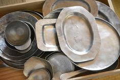 a box filled with lots of silver dishes