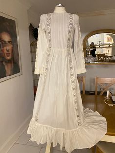 🕊Timeless beautiful white wedding dress by Laura Ashley 🕊Excellent condition with no flaws to note 🕊Pleated bodice and fits like a dream 🕊Measurements are vintage size 14 🕊18" pit to pit?>38"   🕊14" waist> 28"  🕊Hips free  🕊Cotton and beautiful lace trim details on the sleeves and bodice 🤍Button cuffs 🤍Concealed zipper at the back  🤍Long full flounce and flowing dress 🕊Look like an ethereal vampires wife in this showstopper of a timeless piece Victorian White Ball Gown Dress, White Victorian Ball Gown Dresses, Victorian White Ball Gown, Cream Victorian Ball Gown For Wedding, Regency Style White Victorian Dress For Debutante Ball, White Regency Victorian Dress For Debutante Ball, White Regency Style Victorian Dress For Debutante Ball, Full Length Victorian Dress For Wedding, Regency Style Full Length Wedding Dress