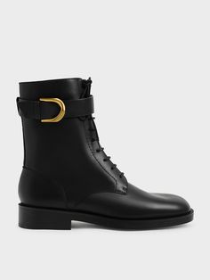 With a minimal silhouette and a classic almond toe, the focal point of our leather ankle boots indubitably lies in the signature gold-tone buckle which is synonymous with our covetable Gabine range. Made from supple calf leather and rendered in a sleek black hue, these laced-up gems are sufficiently sturdy and versatile enough to be worn on a regular basis with all of your outfit pairings. Look effortlessly stylish by teaming them with a trench coat and tweed shift dress combination. Combat Boots Dress, Stacked Heel Ankle Boots, Dress Paris, Tweed Shift Dress, Airport Fashion, Block Heel Boots, Charles Keith, Lace Up Ankle Boots, Thigh High Boots