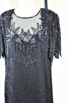 "Beautiful plus size Beaded and sequined black dress...perfect for that soiree that you have been wanting to go to for so long!! Excellent condition!! Measuring: 42\" length Bust: 46\"+ Waist: 42\" Hip: 50\" Pet Free/smoke free Enjoy!" Black Elegant Sequin Fabric For Evening, Black Sequin Fabric For Evening, Elegant Black Sequin Fabric For Evening, Elegant Embellished Sequin Fabric For Evening, Elegant Embellished Evening Sequin Fabric, Elegant Sequin Fabric For Evening Dress And Festive Occasions, Elegant Festive Sequin Fabric For Evening Dress, Short Sleeve Sequin Evening Dress For Party Season, Elegant Black Sequin Fabric For Party Season