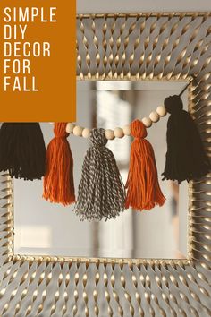 three tassels hanging from a mirror with the words simple diy decor for fall