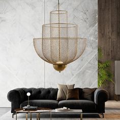 a living room with a couch, coffee table and chandelier hanging from the ceiling