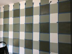 the wall is being painted with gray and white squares