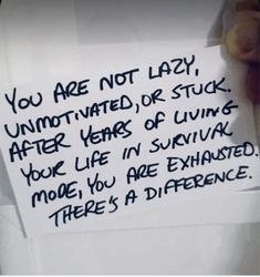 a hand holding a piece of paper that says you are not lazy, unmotched or stuck after years of living