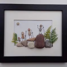 some rocks and plants in a black frame