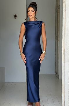 YOU are the moment in the Azuri maxi. a dreamy maxi dress made from bias cut satin which drapes beautifully and hugs the body in all the right places. With a modern high neck and fluid skirt. this design is complete with a showstopping cut out back.   Colour: Navy. Premium bias cut satin. Drapes beautifully. High neckline. Cut out back. Tie detailing to back. Maxi length. Model is an XS and is wearing an XS. Long Sleeve Homecoming Dresses, Dresses Flowy, Maxi Dress Sale, Popular Dresses, Sparkle Dress, Silk Gown, Maxi Dress Navy, Dresses By Length, Out Back