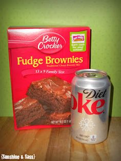 a can of diet coke and brownies next to a box of fudge brownies