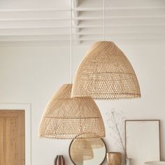 two lamps hanging from the ceiling in a room