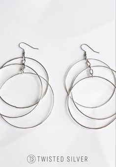 Three timeless rings suspended from an elegant vintage chain are some of our top-choice earrings. Modern Twist Nickel Free Hoop Earrings, Modern Twist Silver Hoop Earrings With Ear Wire, Modern Twist Hoop Earrings In Metal, Modern Twist Silver Earrings With Polished Finish, Modern Twist Sterling Silver Hoop Earrings Gift, Timeless Rings, Wire Chandelier, Timeless Ring, Vintage Chain