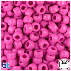 pink plastic beads with holes in the middle and bottom are stacked on top of each other