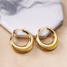 These medium-sized hoops offer a sleek and timeless design, exuding both strength and sophistication. Their waterproof feature ensures they maintain their radiance through any adventure, making them the ideal choice for modern, active lifestyles. Embrace the bold and versatile design of these earrings, which effortlessly complement both casual and formal looks, adding a touch of enduring luxury to your everyday style.Diameter: 4cmStainless Steel;18K Gold Plated;Nickel-free, Hypoallergenic & Wate Cheap Modern Tarnish Resistant Jewelry, Cheap Classic Round Jewelry, Cheap Nickel Free Modern Jewelry, Luxury Gold-plated Hoop Earrings For Women, Cheap Modern Gold-tone Jewelry, Round Earrings Circles Gold, Round Earrings Circles, Thick Hoop Earrings, Chunky Hoop Earrings