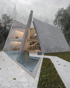 an unusual house in the middle of a field with water and grass on both sides