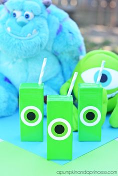 monsters and toothbrushes are sitting on a table next to green boxes with eyes