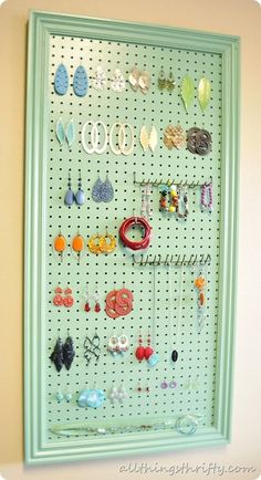 a peg board with earrings hanging on it