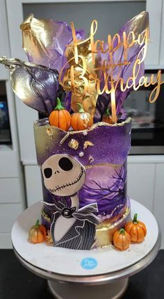 a birthday cake decorated with pumpkins and decorations