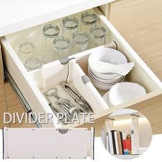 an open drawer with dishes and utensils in it