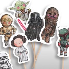 star wars cake toppers are arranged on sticks