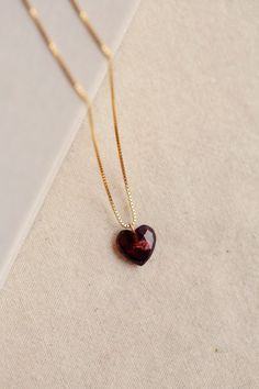 The Charlotte Necklace is a romantic piece featuring a deep red faceted garnet heart stone. This Necklace is handmade with an adjustable length 14k gold-filled chain. The deep red color of the garnet is said to represent love and passion, making this necklace a thoughtful gift for yourself or a loved one. The heart shape makes these earrings an ideal gift for Valentine's Day, an anniversary, or any other day you want to show affection. Wear with Charlotte Garnet Heart Earrings for a perfect matc Charlotte Necklace, Garnet Heart Necklace, Red Garnet Necklace, خواتم خطوبة, Red Heart Necklace, Garnet Heart, Silk Jewelry, Silk Bag, Heart Stone