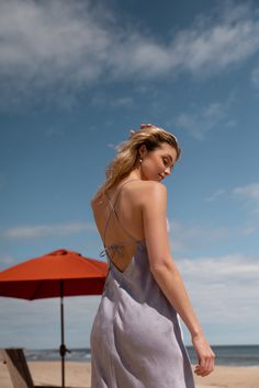 The Jenny Yoo Leilani slip dress is a chic and modern update to the classic slip dress. Featuring a V neck and a delicate spaghetti strap to highlight your shoulders and collarbone. The low scoop back has a barely there feeling, and the bias cut skirt slinks over every curve. A dainty tie at the back adds one last flirtatious detail. Available in Clay Rosette Pink and Oxford Blue. Ready to ship. Shop online now! Spring Dress With Built-in Bra And Strappy Back, Elegant Slip Dress With Built-in Bra And Strappy Back, Feminine V-neck Slip Dress With Delicate Straps, V-neck Slip Dress With Delicate Straps, Feminine Fitted Slip Dress For Summer, Halter Neck Backless Dress For Date Night, Summer Backless Dress With Built-in Bra And Low Back, Summer Slip Dress With Built-in Bra And Strappy Back, Chic Beach Slip Dress With Built-in Bra