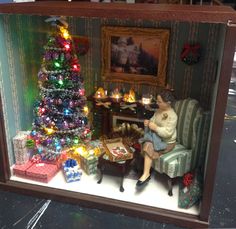 a miniature christmas tree in a doll house