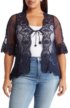 Bring elegant style to any outfit with this tie-front top crafted in a sheer silhouette with scalloped crochet lace trim. 30" length (size 1X) V-neck Three-quarter sleeves Tie front Sheer Crochet lace trim 65% cotton, 35% polyester Hand wash, line dry Imported Model stats: 5'10" height, 41" bust, 36" waist, 48" hip. Model is wearing size 1X. Lace V-neck Top With Crochet Trim, V-neck Lace Top With Scalloped Detail, Spring V-neck Top With Scalloped Lace, Fitted Lace Crochet V-neck Top, V-neck Lace Tops With Crochet Trim, Lace V-neck Top With Open Knit, Lace Open Knit V-neck Top, Fitted Lace V-neck Crochet Top, Open Knit Lace V-neck Top