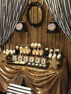 a dessert table with cupcakes, cake and candy bars on top of it