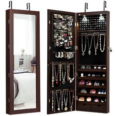 a large wooden jewelry cabinet with mirrors on the sides and shelves filled with necklaces