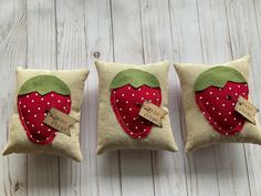 two decorative pillows made to look like strawberries