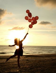 a woman on the beach with balloons in her hand and an ad for perfect match