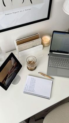 an open laptop computer sitting on top of a white desk next to a cup of coffee