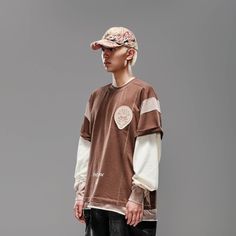 The Deconstructed Patchwork Jersey seamlessly blends street style with athletic aesthetics. Featuring a bold color-block patchwork design, this jersey stands out with its unique look. The left chest sports a branded badge, while the front hem is printed with "Petrichor" and the brand logo. The back is adorned with a thorny leaf patch, adding an extra layer of detail. Made from premium 100% cotton fabric, this jersey ensures both comfort and durability. The oversized fit provides a relaxed, moder Sporty Cotton T-shirt With Patchwork, Winter Patchwork Tops For College, Brown T-shirt For Fall Streetwear, White Patchwork T-shirt For Streetwear, Sporty T-shirt With Contrast Color For Streetwear, White Patchwork Sweatshirt For Streetwear, Cotton Patchwork Top For Streetwear, Patchwork Cotton Tops For Streetwear, Casual T-shirt With Contrast Panels For Streetwear