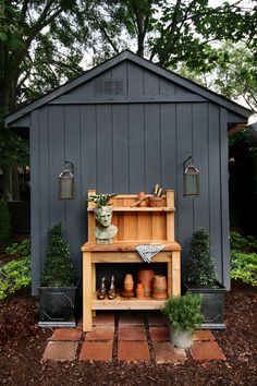 an outdoor potting shed with pots and planters