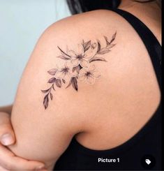 a woman's shoulder with flowers on it