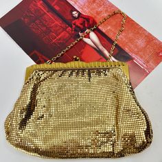 This Whiting & Davis branded handbag is in lovely vintage condition.  All mesh tiles are in tact and none are missing.  No tarnish.  The frame is also in excellent condition with no major scratches and no colour fade.  The same for the inside.  Clean and no stains at all.  Bag looks like it wasnt used and is overall in fabulous condition.  The bag is stamped Whiting and Davis and is style 2932.  Likely from the 60s by the style.    Bag is a great size and is a little larger than others.  Size me Vintage Gold Shoulder Bag For Party, Vintage Gold Shoulder Bag With Gold-tone Hardware, Retro Gold Rectangular Shoulder Bag, Vintage Gold Shoulder Bag For Formal Occasions, Retro Gold Bags With Gold-tone Hardware, Gold Retro Bags With Gold-tone Hardware, Retro Gold Shoulder Bag For Evening, Gold Retro Bags, Gold Retro Shoulder Bag For Evening