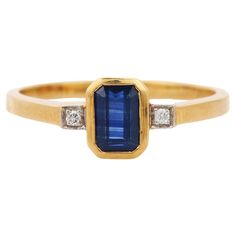 Blue Sapphire ring in 18K Gold which perfectly goes with your personality and also helps you to learning and spiritual healing. Designed with Blue Sapphire in center and diamonds at sides that makes it a perfect fit to wear it on your wedding or style it with any of your basic outfit to give it a glam. PRODUCT DETAILS :- > Material - 18K Solid Yellow Gold > Gemstone - Blue Sapphire > Gemstone Weight - 0.67 ct > Stone Shape - Octagon > Stone Size - 6*4 mm > Diamond Weight - 0.02 ct > Gross Weight - 2.978 Grm > Shank width - 1.6 mm > Setting - Bezel setting We can customize the Gold Gemstone Ring according to your specification. Go to our Storefront Page for more updates and click on the follow button to never miss out on our newly added jewelry collection. All our jewelry products are stamp Luxury Gold Sapphire Ring With Polished Finish, Luxury Gold Sapphire Ring In Modern Style, Luxury Everyday Yellow Gold Sapphire Ring, 14k Gold Blue Rings With Single Cut Diamonds, Yellow Gold Sapphire Baguette Cut Ring With Accent Stones, Yellow Gold Emerald-cut Sapphire Ring With Accent Stones, Yellow Gold Emerald-cut Sapphire Diamond Ring, Emerald Cut Sapphire Diamond Ring In Yellow Gold, Yellow Gold Cocktail Ring