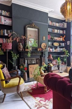 a living room filled with lots of furniture and bookshelves next to a fire place