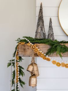 a christmas mantle with ornaments and bells on it