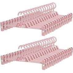 two pink plastic hangers with clips on each side and one is holding several pairs of clothes