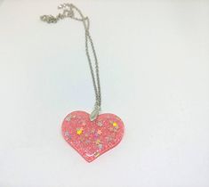 Your choice of ONE fun heart necklace! Unless you choose more than 1! Each necklace is clear resin with fine coordinating glitter with silver holographic stars, cute! PINK: Clear Resin, Fine Pink Glitter, Holographic Stars BLUE: Clear Resin, Fine Blue Glitter, Holographic Stars YELLOW/GOLD: Way more gold than yellow! Cleaer Resin, yellow/gold fine glitter, Holographic Stars Clear: Clear Resin, Silver Glitter, Holographic Stars Just a heads up that you can kind of see through the Clear option the Stars Yellow, Silver Holographic, Glitter Stars, Heads Up, Clear Resin, Blue Glitter, Pink Glitter, Silver Glitter, Heart Necklace