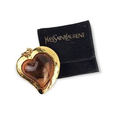 Vintage YSL Yves Saint Laurent Gold Tone Heart Pendant with Amber lucite heart. One side of the pendant you find marked YSL. Marks or signatures: YSL Measures: The pendant measures a little over 5 cm by 4.2 cm Condition : Excellent condition  This pendant comes with original black velvet pouch Vintage Saint Laurent, Ysl Vintage, Ysl Jewelry, Vintage Ysl, Vintage Necklace, Black Velvet, Heart Pendant, Yves Saint Laurent, Jewelry Necklace Pendant