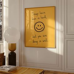 a yellow sign hanging on the wall in a living room with a table and chair