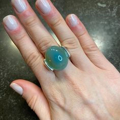 This Sky Blue Cabochon Ring Exudes Elegance With Its Stunning, Iridescent Blue Stone. A Timeless Piece, It Can Be Worn For Any Occasion, Adding A Touch Of Sophistication To Any Outfit. Enhance Your Style With This Beautiful And Versatile Ring. Ring Size 7 Made Of: Sky Blue Agate Silver Plating (7-10 Microns) Over Brass Made In Brazil Disclaimer: Please Note That All Semiprecious Stones Have Imperfections And Are Part Of Their Own Beauty. Due To Changes In Lighting, A Product May Appear Different Elegant Silver Ring Cabochons, Formal Blue Oval Cabochon Moonstone Ring, Blue Round Cabochons For Anniversary, Formal Blue Moonstone Gemstone Ring, Elegant Turquoise Moonstone Ring In Sterling Silver, Silver Round Cabochons For Formal Use, Adjustable Blue Moonstone Cabochon Ring, Adjustable Blue Moonstone Ring With Cabochon, Adjustable Blue Cabochon Moonstone Ring