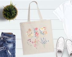 "Vintage Wildflowers Tote Bag, Floral Tote Bag, Shoulder Bag, Wildflower Tote Bag, Mothers Day Gift, Garden Bag, Plant Women Tote Bag Welcome to ComfortTeeStore  Great to see you here. In ourstore, you can find your dream style. 📌Product Description 100% Cotton Material. Standard Size Bag Standard Length (21\") Self-fabric handles Reinforces at stress points for extra durability 📌 Product Size  Measurements -> 15\"W x 16\"H Tolerance -> +/- 1 📌Care Instructions * Wash item inside out in cold White Botanical Style Bag For Spring, Eco-friendly Flower Shaped Bags For Spring, Eco-friendly Flower-shaped Bags For Spring, Spring Botanical Rectangular Bags, Eco-friendly Shoulder Bag Gift For Spring, Eco-friendly Shoulder Bag For Spring Gift, Eco-friendly Floral Print Spring Bags, Botanical Style Bags For Spring Gift, Botanical Style Bags For Spring